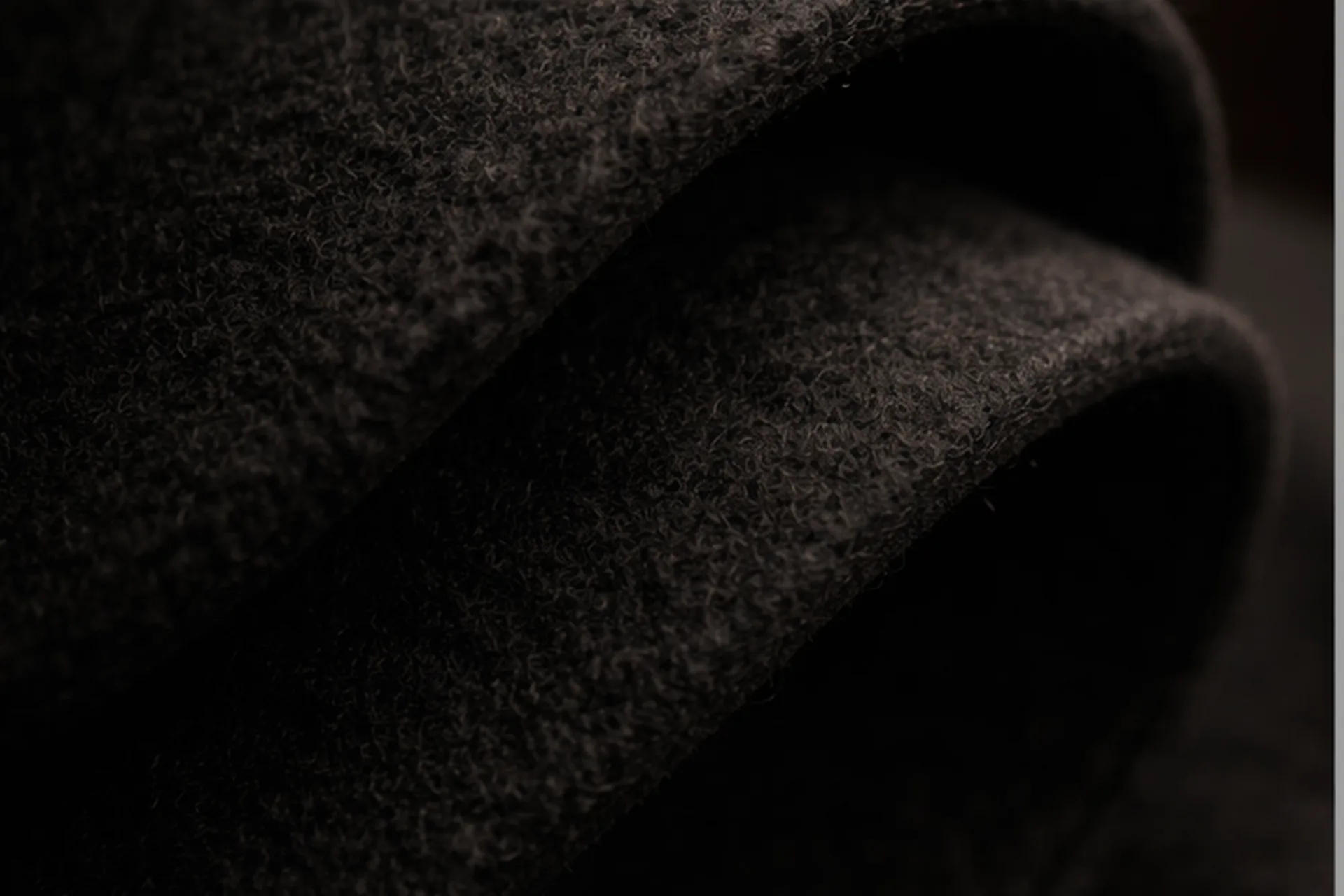 Close-up of dense felted wool texture showing the natural fibre structure
